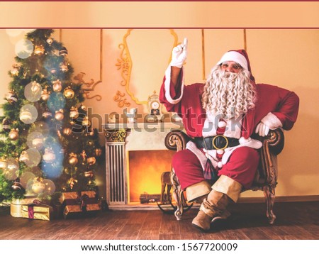 Stockfoto: Santa Claus With Gift Boxs Sitting On Chair With Finger On Lips In Living Room