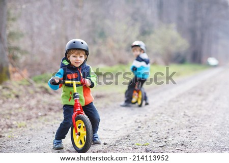 Сток-фото: Two Little Boys Children Having Fun On Balance Bike On A Country Tropical Road