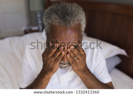 Сток-фото: Portrait Of A Worried Senior African American Man Covering His Eyes In Bedroom At Home