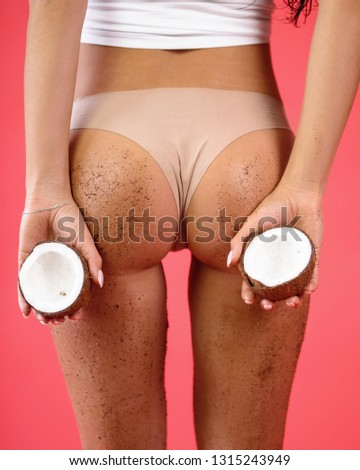 Stock photo: Buttocks And Legs Of A Woman On A Background Of Coconut Shells