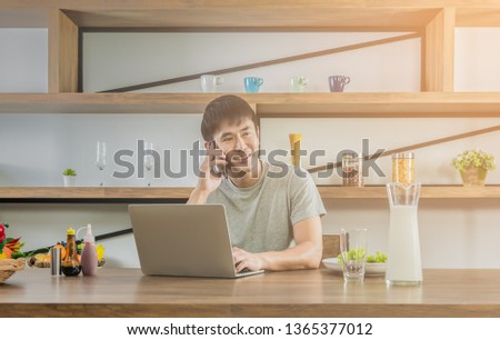 ストックフォト: Young Man Having Breakfast And Using Laptop On The Kitchen Banner Long Format