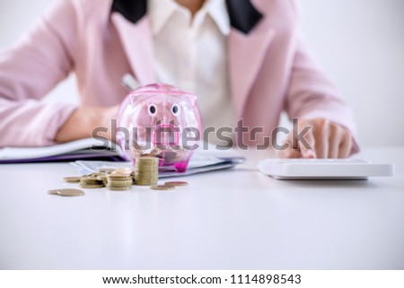 Business Woman Putting Coins Into Piggy Bank Writing To Report Сток-фото © Freedomz