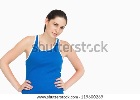 Foto stock: Serious Brunette In Sportswear Hands On Hips Against White Background