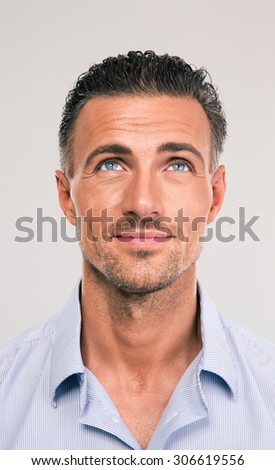 Foto stock: Portrait Of A Pensive Businessman Looking Up Over Gray Background