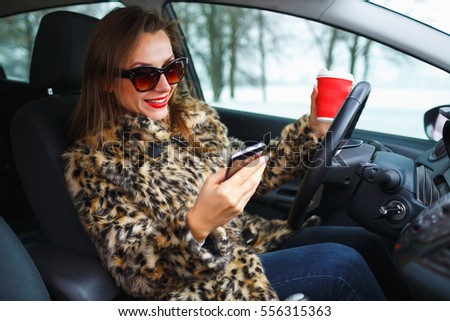 Stock fotó: Businesswoman In A Fur Coat With Red Lips Sending A Text Message
