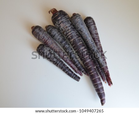 Stock photo: Bunch Of Heirloom Purple Carrots Over White And Wooden Backgrou