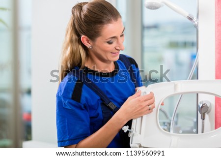 ストックフォト: Female Maintenance Worker Checking The Quality Of A Toilet Seat