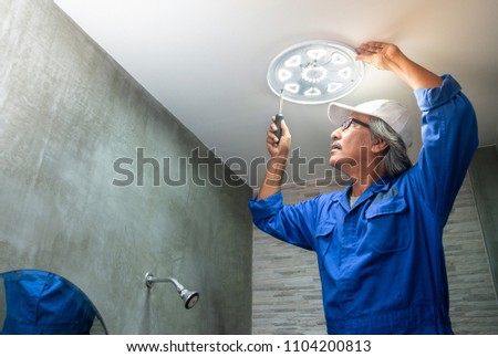 Foto stock: Man Technician Servicing At Work On Electric Room