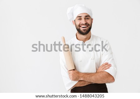 Foto stock: Handsome Young Man Chef Indoors Isolated Over White Wall Background