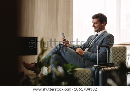 Stock photo: A Man In The Lounge Area At The Airport Is Waiting For His Plane