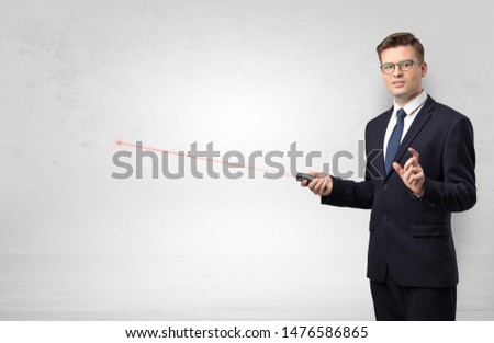 Foto stock: Businessman With Laser Pointer And Copyspace White Blackboard