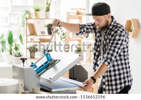 Foto stock: Craftsman Using Special Equipment While Printing Decor On Workpiece Of Collar