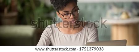Stock foto: Photo Of Woman Works Freelance From Home Concentrated In Monitor Of Computer Wears Spectacles Pos