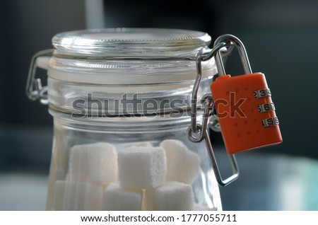 Stock fotó: Glass Jar Of Natural White Refined Sugar With Cubes With Silver Spoon On Light Table Background With