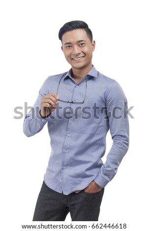 Stock photo: Young Asian Man Wear Blue Shirt Is Happy And Smiling When Pointing And Look Into The Watch Isolated