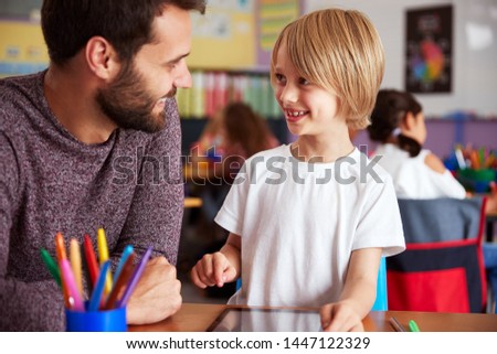 Stock photo: School Pupil With Teacher Using Digital Tablet Computer In Class