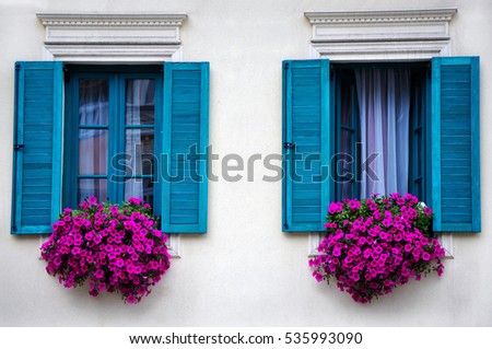 Foto stock: Two Windows With Flowers