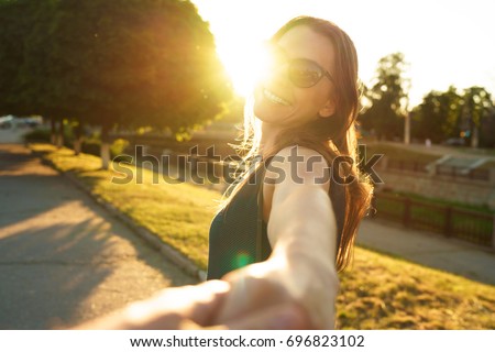 Сток-фото: Happy Young Woman Pulling Guys Hand - Hand In Hand Walking On A