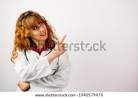 Foto d'archivio: Closeup Shot Of Woman Doctor Or Nurse Pointing To A Blank Copysp