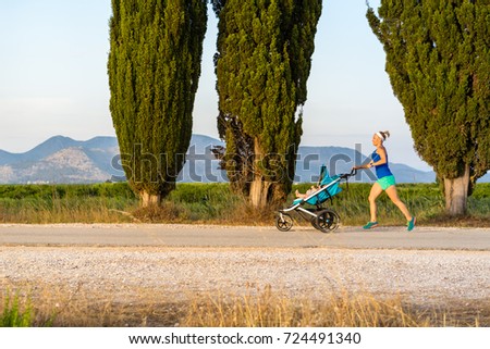 Stok fotoğraf: Running Mother With Stroller Enjoying Motherhood At Sunset Lands