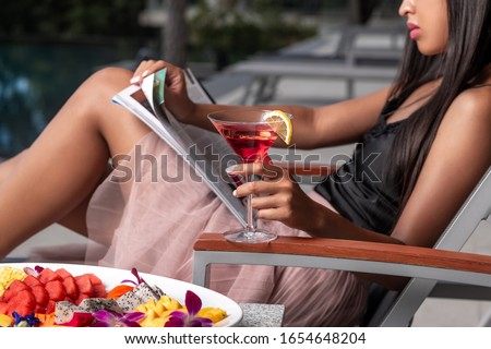 Foto stock: Beautiful Girl Drinking Cosmopolitan Cocktail Lying Swimming Po