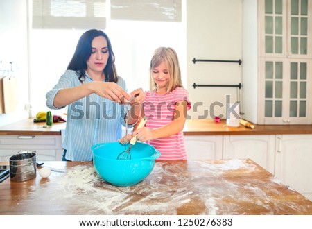 Stockfoto: Happy Mother And Daughter Pouring Flour Through Sieve For Dough