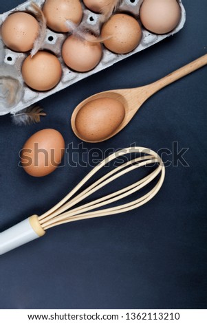 Foto d'archivio: Eggs Wooden Spoon Whisker And Feathers Kitchen Utensil For Ca