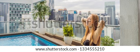 [[stock_photo]]: Young Woman In The Pool Among The Skyscrapers And The Big City