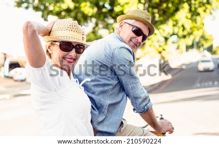 Stok fotoğraf: Side View Of Active Senior Man With Senior Woman Riding Bicycle On The Beach