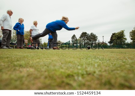 Zdjęcia stock: Low View Of Group Of Concentrated Active Senior People Performing Yoga In The Park