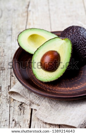 Foto stock: Fresh Organic Avocado On Ceramic Plate And Linen Napkin On Rusti