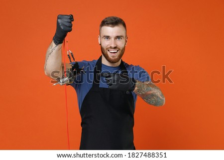 Stok fotoğraf: Cheerful Excited Man With Tattooed Arm In Orange T Shirt Smiling Astonished Telling Something Amazi