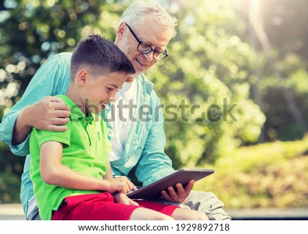 Stok fotoğraf: Happy Grandfather And Boy With Tablet Pc Outdoors