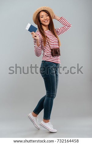 Stock photo: Image Of Happy Brunette Asian Woman Holding Passport And Travel