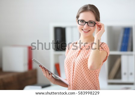 Foto stock: Portrait Of Surprised Woman Holding Diary And Looking At Camera