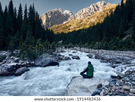 Stockfoto: Man Meditating Near The Mountain River Yoga Practicing Outdoors