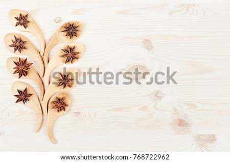 Foto stock: Funny Christmas Tree Of Bamboo Spoons With Anise Stars On White Wood Background
