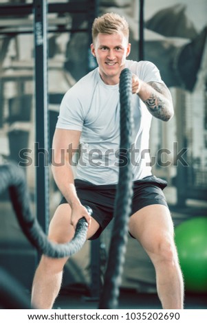 Stok fotoğraf: Handsome Bodybuilder Exercising With Battle Ropes During Functional Training