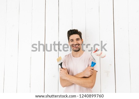 Stok fotoğraf: Image Of Masculine Man 20s Painting White Wall And Making Renova