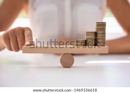 Zdjęcia stock: Businessperson Balancing Increasing Stacked Coins With Finger