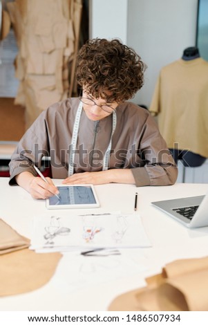 Pretty Young Serious Female Creative Designer Scrolling Through Digital Sketches Сток-фото © Pressmaster