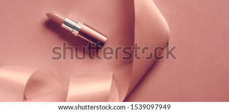 ストックフォト: Luxury Lipstick And Silk Ribbon On Blush Pink Holiday Background