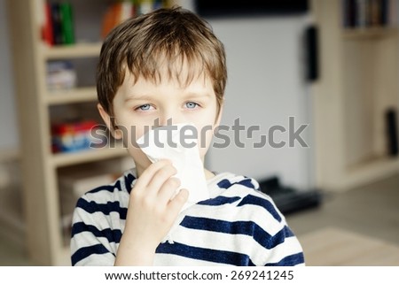 Stok fotoğraf: Sick Boy Coughs And Wipes His Nose With Wipes Sick Child With Fever And Illness In Bed Banner Long