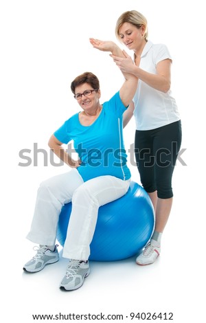 Foto stock: Instructor Assisting Senior Doing Exercise Working Out In Clinic