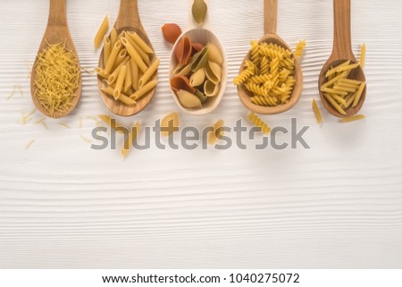 Stok fotoğraf: Different Kinds Of Raw Pasta With Copy Space On Wooden Backgroun