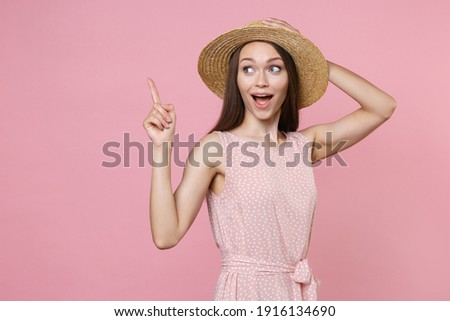 ストックフォト: Portrait Of An Excited Brunette Woman In Dress Pointing Finger