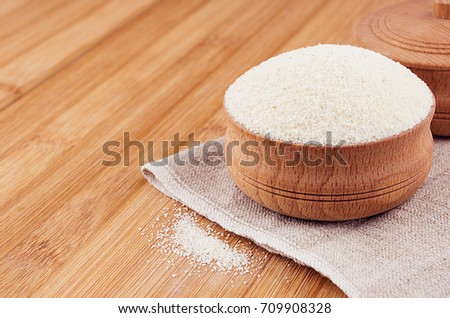Stock fotó: Semolina In Wooden Bowl On Brown Bamboo Board Closeup Healthy Dietary Groats Background