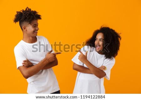 Zdjęcia stock: Cute Young Loving Couple Posing Isolated Over Yellow Background Hugging