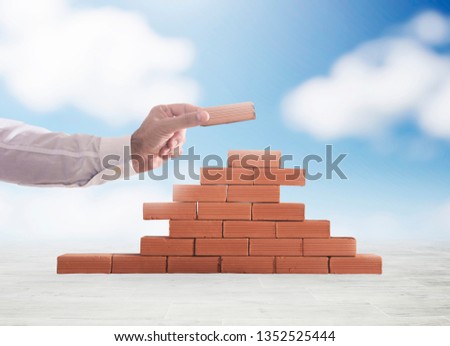 Stok fotoğraf: Businessman Puts A Brick To Build A Wall Concept Of New Business Partnership Integration And Star