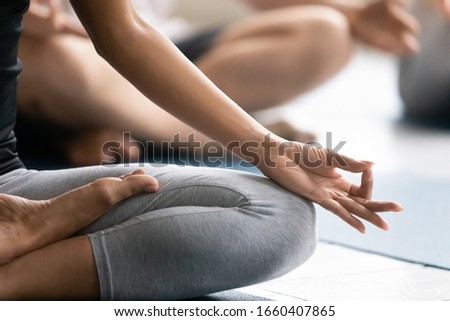 Stock photo: Girl Sitting In Pose Of Lotus With Crossed Legs And Hands Put Together By Chest